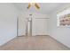 Spacious bedroom featuring speckled floors, windows, and closet for optimal storage at 17111 Mockingbird Ln, Lutz, FL 33548