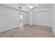 Spacious bedroom with ceiling fan, white walls, and beige floor at 17111 Mockingbird Ln, Lutz, FL 33548
