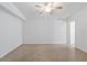 Spacious bedroom with ceiling fan, white walls, and beige floor at 17111 Mockingbird Ln, Lutz, FL 33548