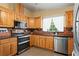 Well-lit kitchen with stainless steel appliances and wooden cabinets at 17111 Mockingbird Ln, Lutz, FL 33548