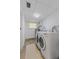 Bright laundry area with washer and dryer hookups, tiled ceiling, and small window at 17111 Mockingbird Ln, Lutz, FL 33548