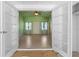 View through double doors into a light and airy living room with terrazzo floors and a ceiling fan at 17111 Mockingbird Ln, Lutz, FL 33548