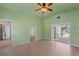 Bright living room with a ceiling fan and terrazzo flooring, offering plenty of natural light at 17111 Mockingbird Ln, Lutz, FL 33548
