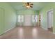 Inviting living area with a ceiling fan, windows, and a door offering a glimpse into the kitchen at 17111 Mockingbird Ln, Lutz, FL 33548
