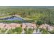 Stunning aerial view showcasing beautiful homes, serene lake, and lush green forest, perfect for nature lovers at 17537 Fairmeadow Dr, Tampa, FL 33647