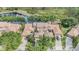 Overhead view displaying homes nestled near a peaceful lake and forest, merging residential living with natural beauty at 17537 Fairmeadow Dr, Tampa, FL 33647
