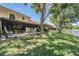 Inviting screened lanai with comfortable seating overlooking a lush green lawn and a tranquil waterfront at 17537 Fairmeadow Dr, Tampa, FL 33647