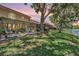 This home features a relaxing backyard with a patio, outdoor seating, and serene pond views at 17537 Fairmeadow Dr, Tampa, FL 33647