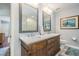Bright bathroom featuring a double sink vanity with marble top, and framed mirrors at 17537 Fairmeadow Dr, Tampa, FL 33647