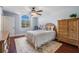 Cozy bedroom with a vaulted ceiling, arched window, and classic wood furniture at 17537 Fairmeadow Dr, Tampa, FL 33647