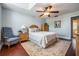 Comfortable bedroom with vaulted ceiling, hardwood floors, arched window, and classic wood furniture at 17537 Fairmeadow Dr, Tampa, FL 33647