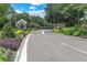 Well-maintained community entrance with beautiful landscaping along the road and a guard house at 17537 Fairmeadow Dr, Tampa, FL 33647