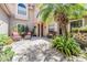 Inviting courtyard with brick pavers, lush greenery, and comfortable seating area at 17537 Fairmeadow Dr, Tampa, FL 33647