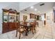 A dining room featuring a wooden table, decorative display case, and easy access to the kitchen area at 17537 Fairmeadow Dr, Tampa, FL 33647