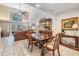 Sunlit dining area with a stylish table, comfortable seating, and views of the living room and backyard at 17537 Fairmeadow Dr, Tampa, FL 33647