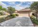 A charming one-story home features a spacious two-car garage and mature landscaping, providing excellent curb appeal at 17537 Fairmeadow Dr, Tampa, FL 33647