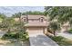 Charming home featuring a tile roof and a well-maintained two-car garage with a concrete driveway at 17537 Fairmeadow Dr, Tampa, FL 33647
