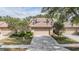 Charming home featuring a tile roof and a well-maintained two-car garage with a concrete driveway at 17537 Fairmeadow Dr, Tampa, FL 33647