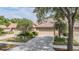 Charming home featuring a tile roof and a well-maintained two-car garage with a concrete driveway at 17537 Fairmeadow Dr, Tampa, FL 33647