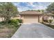 Single-story home showcasing a two-car garage, tile roof, manicured landscaping, and a well-maintained driveway at 17537 Fairmeadow Dr, Tampa, FL 33647