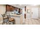 A kitchen featuring a breakfast bar, modern appliances, and seamless transition to the dining area at 17537 Fairmeadow Dr, Tampa, FL 33647