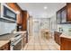 Bright kitchen with stainless appliances, tile flooring, and a cozy dining area with shuttered windows at 17537 Fairmeadow Dr, Tampa, FL 33647