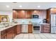 Spacious kitchen with stainless steel appliances, blue backsplash, and custom cabinetry for ample storage at 17537 Fairmeadow Dr, Tampa, FL 33647