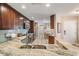 A view of the kitchen showcasing granite counters, modern appliances, and a bright, open layout at 17537 Fairmeadow Dr, Tampa, FL 33647