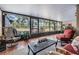 Relaxing screened lanai with comfortable seating and peaceful views of the surrounding nature at 17537 Fairmeadow Dr, Tampa, FL 33647