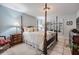 Spacious main bedroom with large window, plantation shutters, dark wood furniture, and a comfortable four-poster bed at 17537 Fairmeadow Dr, Tampa, FL 33647