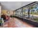 Spacious screened-in patio with comfortable seating and views of the lake at 17537 Fairmeadow Dr, Tampa, FL 33647