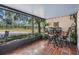 Screened in patio with table and chairs offering beautiful lake view at 17537 Fairmeadow Dr, Tampa, FL 33647