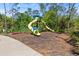 A vibrant playground is set amidst a lush, green environment with towering trees for shade at 17537 Fairmeadow Dr, Tampa, FL 33647