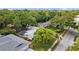 Stunning aerial view of home showcasing lush landscaping, pool, and charming neighborhood at 1905 Oro Ct, Clearwater, FL 33764