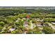 An aerial view of the property, nestled among the lush trees and other homes in the area at 1905 Oro Ct, Clearwater, FL 33764