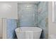 Elegant bathroom featuring a freestanding tub with blue accent wall and a gold faucet at 1905 Oro Ct, Clearwater, FL 33764
