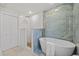 Luxurious bathroom featuring a soaking tub and a glass-enclosed shower at 1905 Oro Ct, Clearwater, FL 33764
