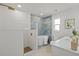 Modern bathroom featuring a soaking tub, glass-enclosed shower, and sleek fixtures at 1905 Oro Ct, Clearwater, FL 33764