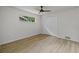 Simple bedroom with wood-style flooring, a window, and a double door closet at 1905 Oro Ct, Clearwater, FL 33764