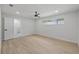 Spacious bedroom with a ceiling fan, a window, and wood-look tile flooring at 1905 Oro Ct, Clearwater, FL 33764