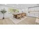 Stylish dining area with wood-look tile flooring, a rustic table, and modern accents at 1905 Oro Ct, Clearwater, FL 33764