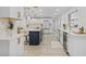 Spacious kitchen with a central island, white cabinetry, gold hardware, and modern appliances at 1905 Oro Ct, Clearwater, FL 33764