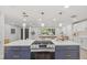 Open concept kitchen featuring a large island with stainless steel appliances and pendant lighting at 1905 Oro Ct, Clearwater, FL 33764