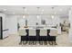 Modern kitchen island with bar seating, pendant lighting, and sleek white countertops at 1905 Oro Ct, Clearwater, FL 33764