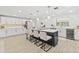 Well-equipped kitchen with a large island, modern lighting, and sleek, white cabinetry at 1905 Oro Ct, Clearwater, FL 33764