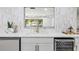 Kitchen featuring elegant white countertops, marble backsplash, wine cooler, and undermount sink at 1905 Oro Ct, Clearwater, FL 33764