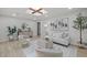 Stylish living room featuring neutral furniture, modern decor, and wood-look tile flooring at 1905 Oro Ct, Clearwater, FL 33764
