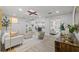Bright, airy living room with a decorative ceiling element and light hardwood-style floors at 1905 Oro Ct, Clearwater, FL 33764