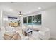 Bright living room with tile floors, patio access, and views of the pool at 1905 Oro Ct, Clearwater, FL 33764