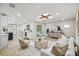 Stylish living room featuring light hardwood floors, a modern ceiling fixture, and lots of natural light at 1905 Oro Ct, Clearwater, FL 33764
